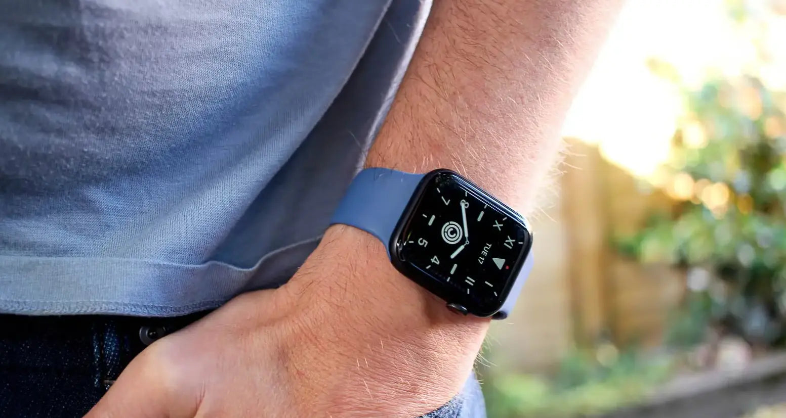 Smartwatch on a wrist with a blurred outdoor background